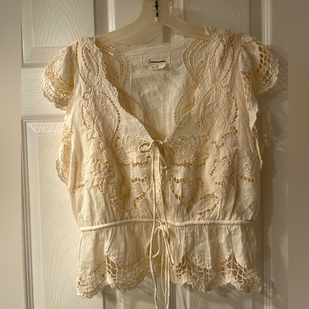 Lacey top with cap sleeves and built-in camisole. Worn once.